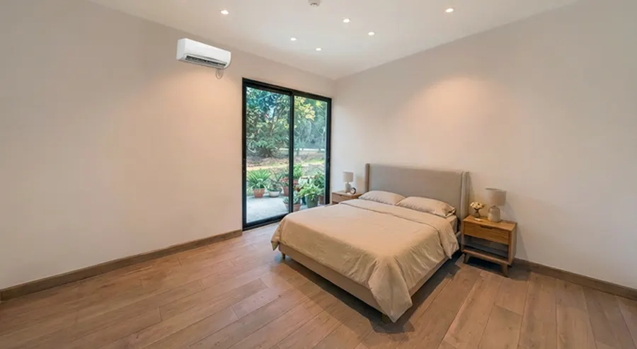 Second bedroom of Casa Valley with sliding glass door to the garden