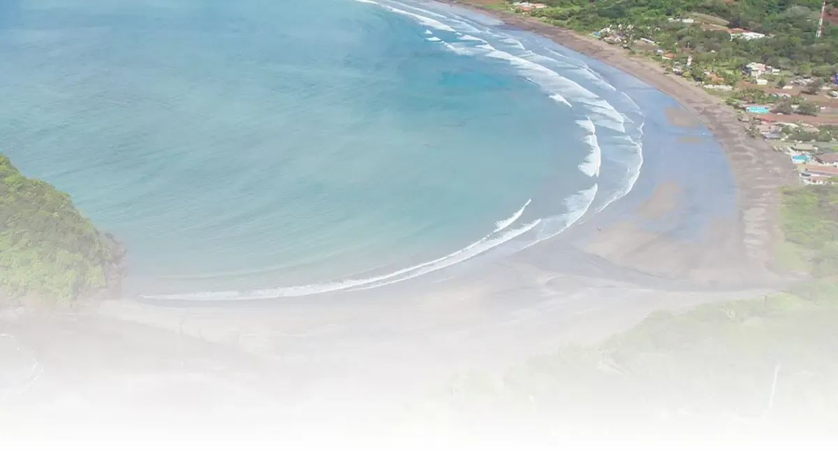 Aerial view of Playa Venao bay fading into the page